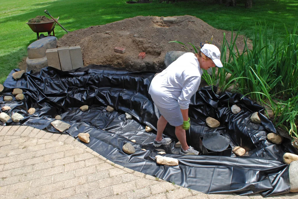 Installing liner in a backyard pond - Grass Roots Pond And Garden Installing liner in a backyard pond