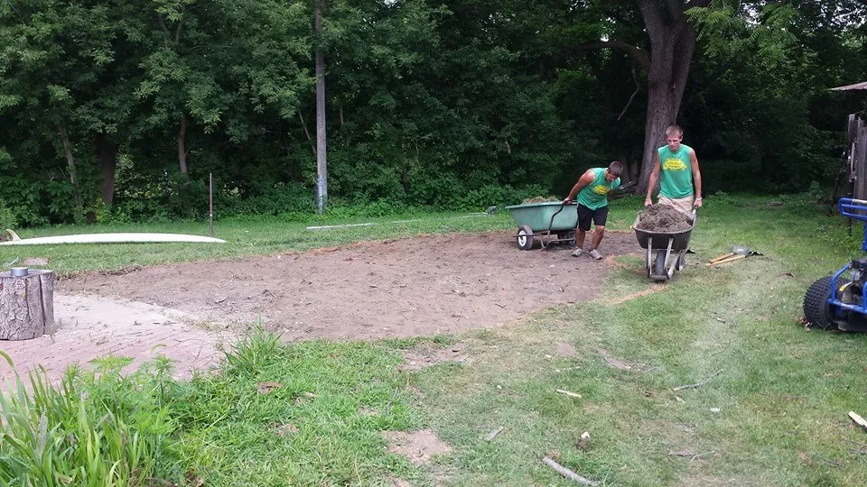 Pond crew hauling dirt from dig site - Grass Roots Pond And Garden Pond crew hauling dirt from dig site