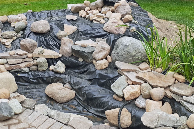 Backyard-DIY-water-feature-project-with-pond-and-waterfall-under-construction - Grass Roots Pond And Garden Backyard DIY water feature project with a pond and waterfall under construction
